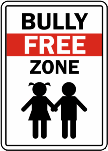 A sign that says 'Bully Free Zone' with silhouettes of a girl and a boy holding hands displayed underneath the text.