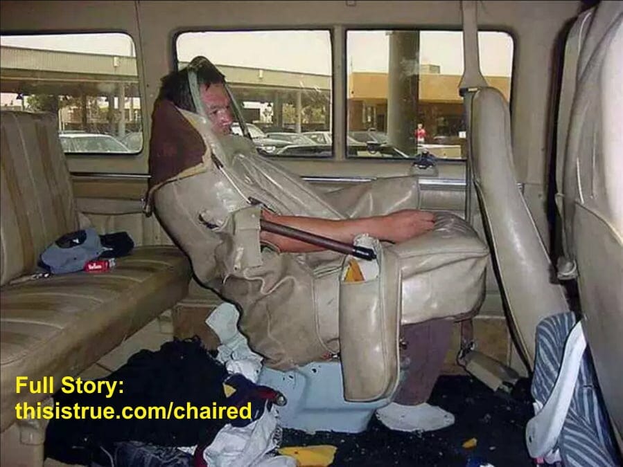 A seat cover in the back of a van has been open up to reveal a man IS the seat.