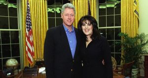 President Bill Clinton in the Oval Office, standing with his arm around a smiling Monica Lewinski.