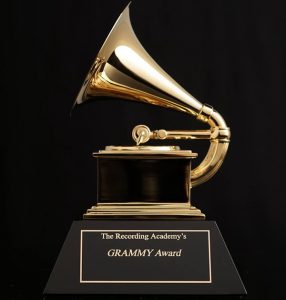 A shiny Grammy award with a black background. The Grammy looks like (and is named for) a Grammophone.