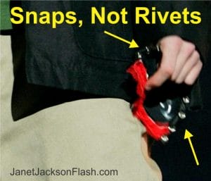 A close-up of a hand holding a black bra cup with red lining and silver snaps. Yellow text over the image reads, "Snaps, Not Rivets."