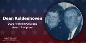 A photo of Dean Koldenhoven with his wife, beside text reading: “Dean Koldenhoven, 2002 Profile in Courage Award Recipient.” Background features star patterns and the John F. Kennedy Library Foundation logo.