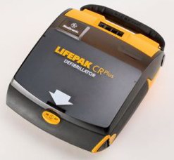 A black and yellow LIFEPAK CR Plus defibrillator on a white surface.