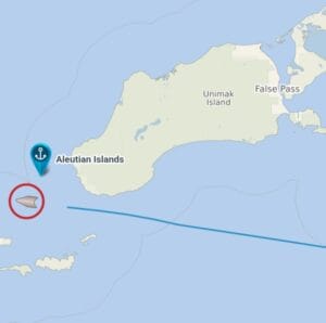 A map showing Unimak Island in Alaska, labeled with False Pass and Aleutian Islands. A blue anchor icon marks the Aleutian Islands, and a red-circled gray icon appears southwest of the island, showing the position of our ship.