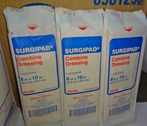 A display of sterile 'Surgipad Combine Dressing' in easy-open packages, each 8x10 inches.