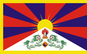 The flag of Tibet features a golden sun rising over snowy mountains, with red and blue rays, a white triangle containing two green snow lions, and a yellow border.