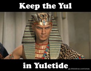 A man dressed as an ancient Egyptian pharaoh poses under the text “Keep the Yul in Yuletide,” which appears above and below him.