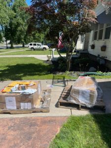Pallets of boxes in driveway.