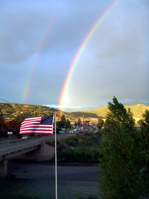 Rainbow ends at the American Flag.