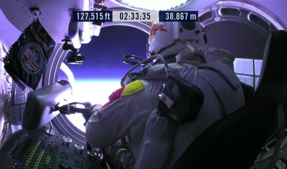 Baumgartner opens the door of his capsule, getting ready to climb out.